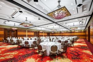 a banquet hall with white tables and chairs at Hilton Lac-Leamy in Gatineau +148 photos