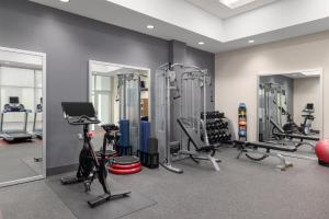 a gym with several treadmills and exercise bikes at Embassy Suites Charlotte/Ayrsley in Charlotte