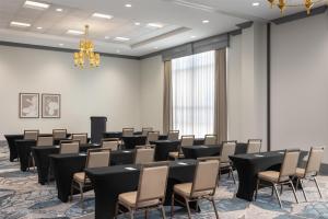 a room with rows of chairs and a chandelier at Embassy Suites Charlotte/Ayrsley in Charlotte +47 photos