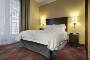 a hotel room with a large bed and a window at Hampton Inn & Suites Mexico City - Centro Historico in Mexico City +59 photos