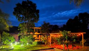 a building lit up at night with lights at Camisão CasaJuMa Pixixi in Aquidauana