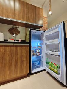 a refrigerator with its door open in a kitchen at Tahanan in Iloilo City