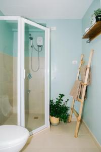 a bathroom with a shower and a toilet and a ladder at Tahanan in Iloilo City +14 photos