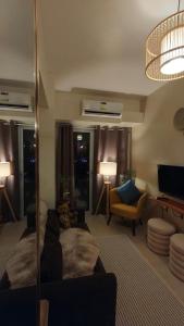 a living room with a bed and a couch at Tahanan in Iloilo City
