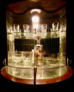 a glass table with a bottle and glasses on it at Vojko Holidays - Rustika in Koper