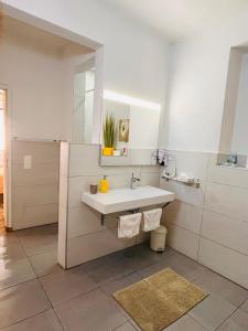 a white bathroom with a sink and a mirror at Faro Town House in Faro +37 photos
