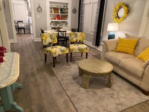 a living room with a couch and chairs and a table at Classic California Bungalow Downtown in Bakersfield