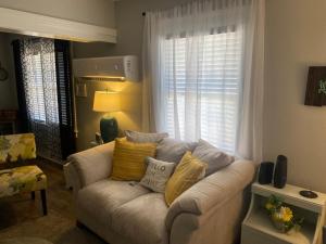 a living room with a couch and a window at Classic California Bungalow Downtown in Bakersfield