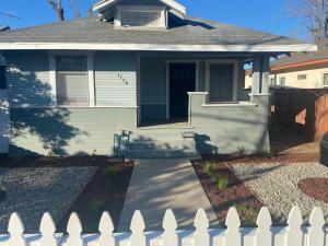 a white fence in front of a house at Classic California Bungalow Downtown in Bakersfield