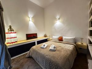 a bedroom with a bed with two towels on it at Riad Medina Charme et Sérénité in Essaouira