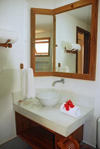 W łazience znajduje się umywalka i lustro. w obiekcie Pousada Coisa e Tao w mieście Arraial d'Ajuda