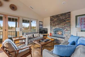 a living room with a couch and a fireplace at Big Mountain View Condo in Sisters
