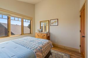a bedroom with a bed and a window at Big Mountain View Condo in Sisters +46 photos