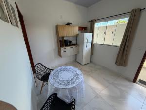 a small kitchen with a table and a refrigerator at VivaVida Bounganvilli 02 in Sinop