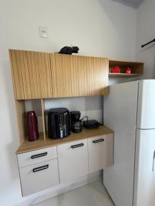 a kitchen with a counter with a microwave and a refrigerator at VivaVida Bounganvilli 02 in Sinop +5 photos