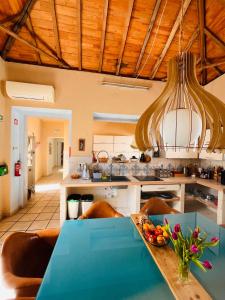 a kitchen with a table with a bowl of fruit on it at Faro Town House in Faro
