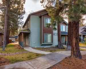a house with trees in front of it at Timber Creek Escape in Sisters