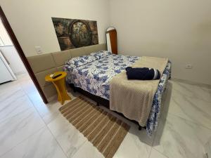 a bedroom with a bed and a yellow stool at VivaVida Bounganvilli 02 in Sinop