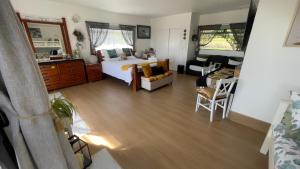 a bedroom with a bed and a living room at Mels Retreat in Te Kuiti