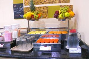 a buffet with two baskets of fruits and vegetables at Hampton Inn Tampico Zona Dorada in Tampico