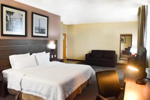 a hotel room with a large bed and a chair at Hampton Inn Tampico Zona Dorada in Tampico +55 photos