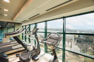 a gym with two cardio machines in a building at DoubleTree by Hilton Hotel Cluj - City Plaza in Cluj-Napoca