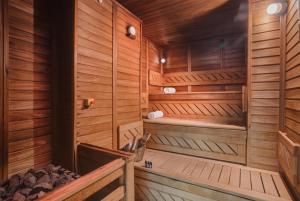 a sauna with wooden walls and wooden flooring at DoubleTree by Hilton Hotel Cluj - City Plaza in Cluj-Napoca