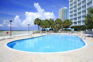 a large swimming pool in front of a building at The Island House Hotel a Doubletree by Hilton in Orange Beach