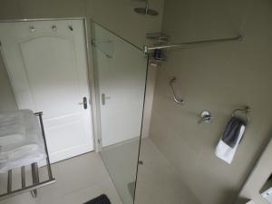 a bathroom with a shower and a glass door at 10 Kommandeurs Ave, Stellenbosch in Stellenbosch +9 photos