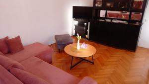 a living room with a couch and a table at House Vrisnik in Jelsa