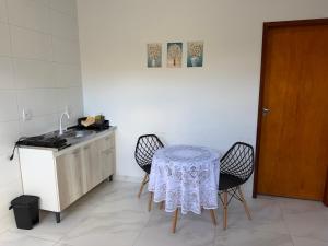 a kitchen with a table with two chairs and a sink at VivaVida boungavilli 01 in Sinop
