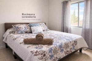 a bedroom with a bed with a towel on it at Casa Nobleza in Manuel F. Martínez
