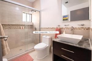 a bathroom with a toilet and a sink and a shower at Casa Nobleza in Manuel F. Martínez +23 photos