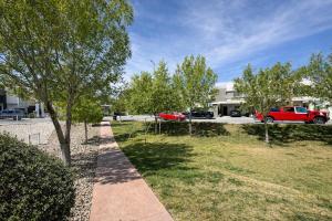 a park with trees and a red truck in a parking lot at Casa Nobleza in Manuel F. Martínez