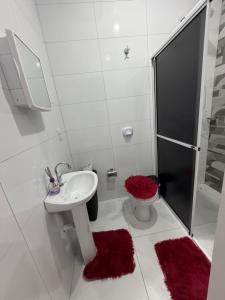a bathroom with a sink and a shower and a toilet at VivaVida boungavilli 01 in Sinop