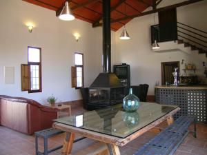 a living room with a table and a fireplace at Casas Rurales Venta Seca complejo Rural para 24-28 plazass in Mazarrón