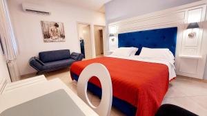 a bedroom with a large bed with a blue headboard at Olimpo degli Dei in Agerola