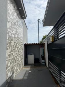 a garage with a white brick wall and a building at VivaVida boungavilli 01 in Sinop