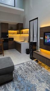 a living room with a tv and a kitchen at Vincaza villa in Tlekung