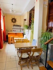 a restaurant with tables and chairs and a counter at Big Vacation Hostel in Cusco
