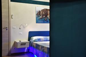 a small bedroom with a bed and a night stand at Casa Anna in Santa Maria