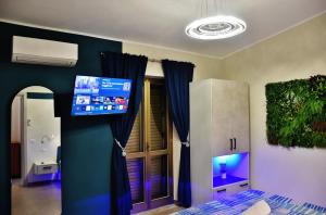 a bedroom with a tv on the wall and a bed at Casa Anna in Santa Maria