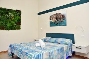 a bedroom with a bed and a picture on the wall at Casa Anna in Santa Maria
