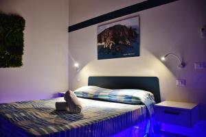 a bedroom with a bed and a picture on the wall at Casa Anna in Santa Maria