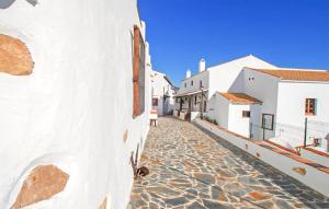a cobblestone street in a town with white buildings at El Pajar in Málaga