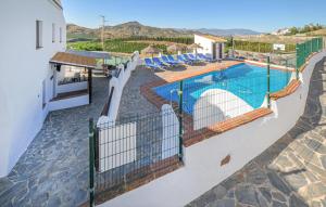 a villa with a swimming pool and views of the mountains at El Pajar in Málaga