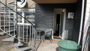 a patio with a chair and a stair case at Ferienwohnung Safran 2 in Konz +1 photo
