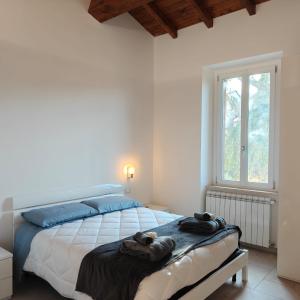 a bedroom with a bed with two towels on it at The Garden Suites in Viterbo