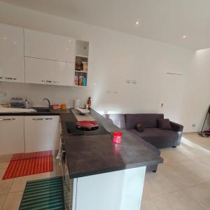 a kitchen with a counter top and a couch at The Garden Suites in Viterbo +25 photos