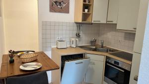 a small kitchen with a table and a sink at Ferienwohnung Safran 2 in Konz
